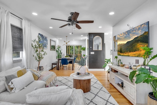 living room with light hardwood / wood-style flooring, ceiling fan, and cooling unit