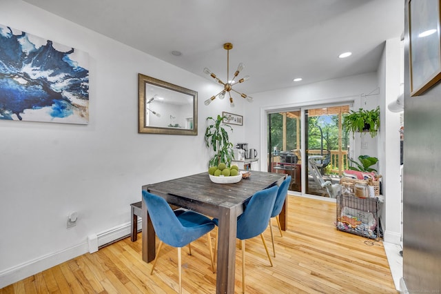 dining area featuring light wood-type flooring and a baseboard radiator