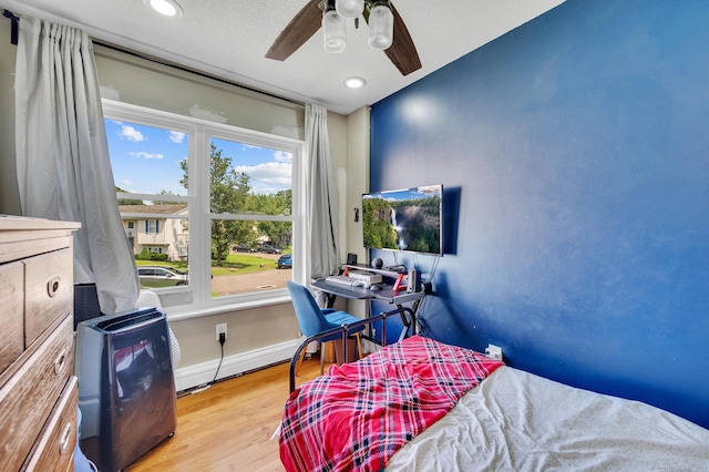 bedroom featuring light wood-type flooring and ceiling fan