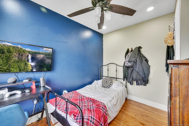 bedroom with ceiling fan and light hardwood / wood-style flooring