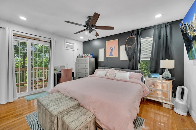 bedroom featuring hardwood / wood-style flooring, ceiling fan, and access to outside