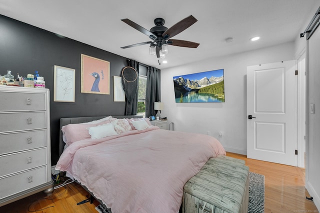 bedroom featuring ceiling fan and light hardwood / wood-style flooring