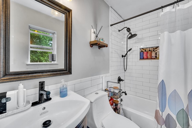 full bathroom with toilet, shower / bath combo with shower curtain, sink, and tile walls