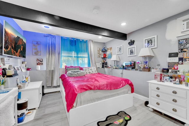 bedroom featuring beam ceiling, baseboard heating, and light hardwood / wood-style flooring