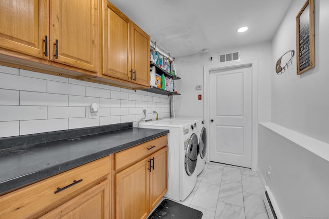 laundry area featuring cabinets, independent washer and dryer, and a baseboard radiator