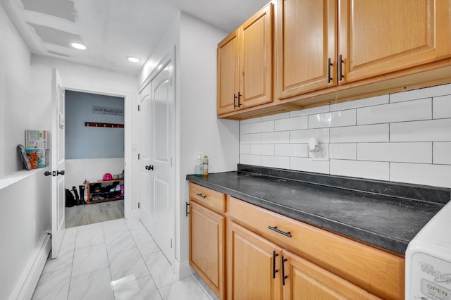 kitchen featuring backsplash and a baseboard heating unit