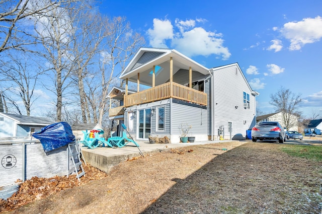 rear view of property with a balcony