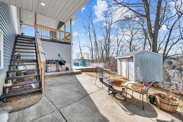 view of patio / terrace featuring a shed and an outdoor fire pit