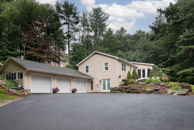 view of front facade with a garage and french doors