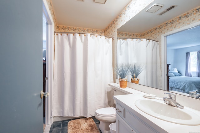 bathroom with vanity, toilet, curtained shower, and tile patterned flooring