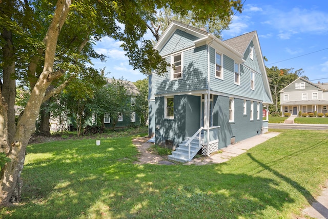 view of side of home with a yard