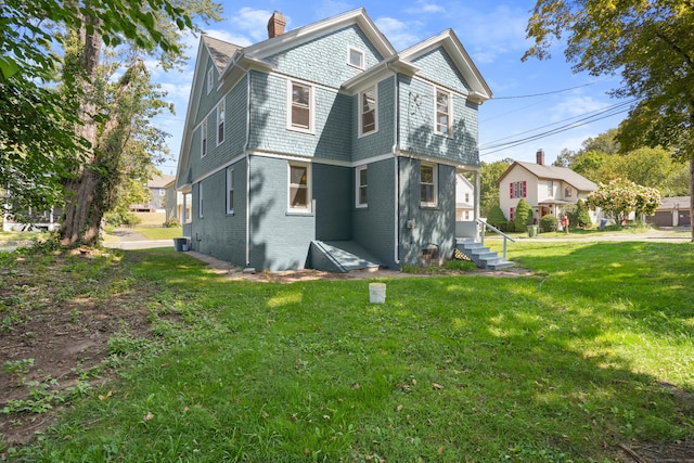 rear view of house with a lawn