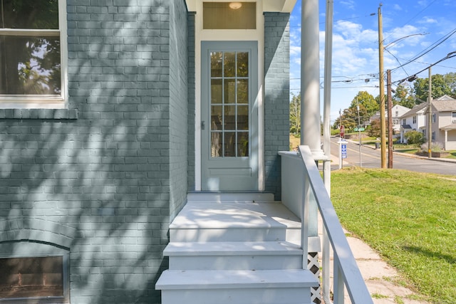 property entrance with a yard