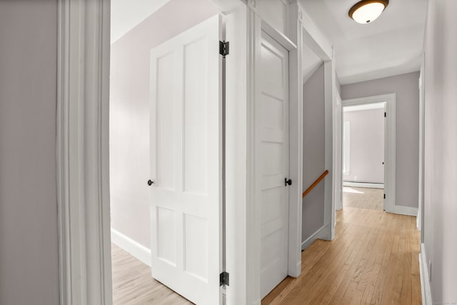 hallway featuring a baseboard radiator and light wood-type flooring