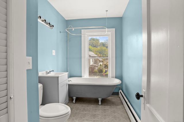 bathroom with toilet, a tub, vanity, and a baseboard radiator