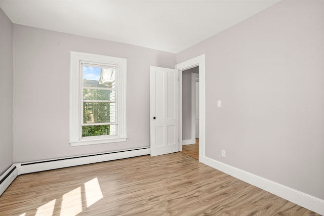 spare room featuring light hardwood / wood-style flooring and a baseboard radiator