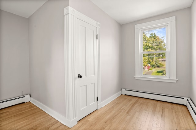 interior space with light hardwood / wood-style flooring and baseboard heating