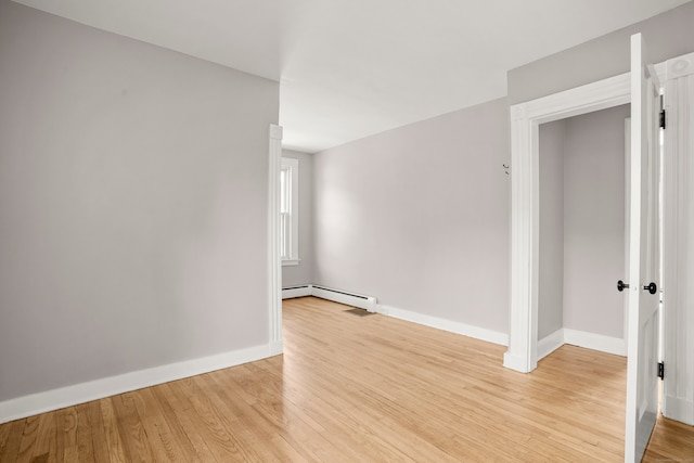 spare room featuring light hardwood / wood-style flooring and a baseboard radiator