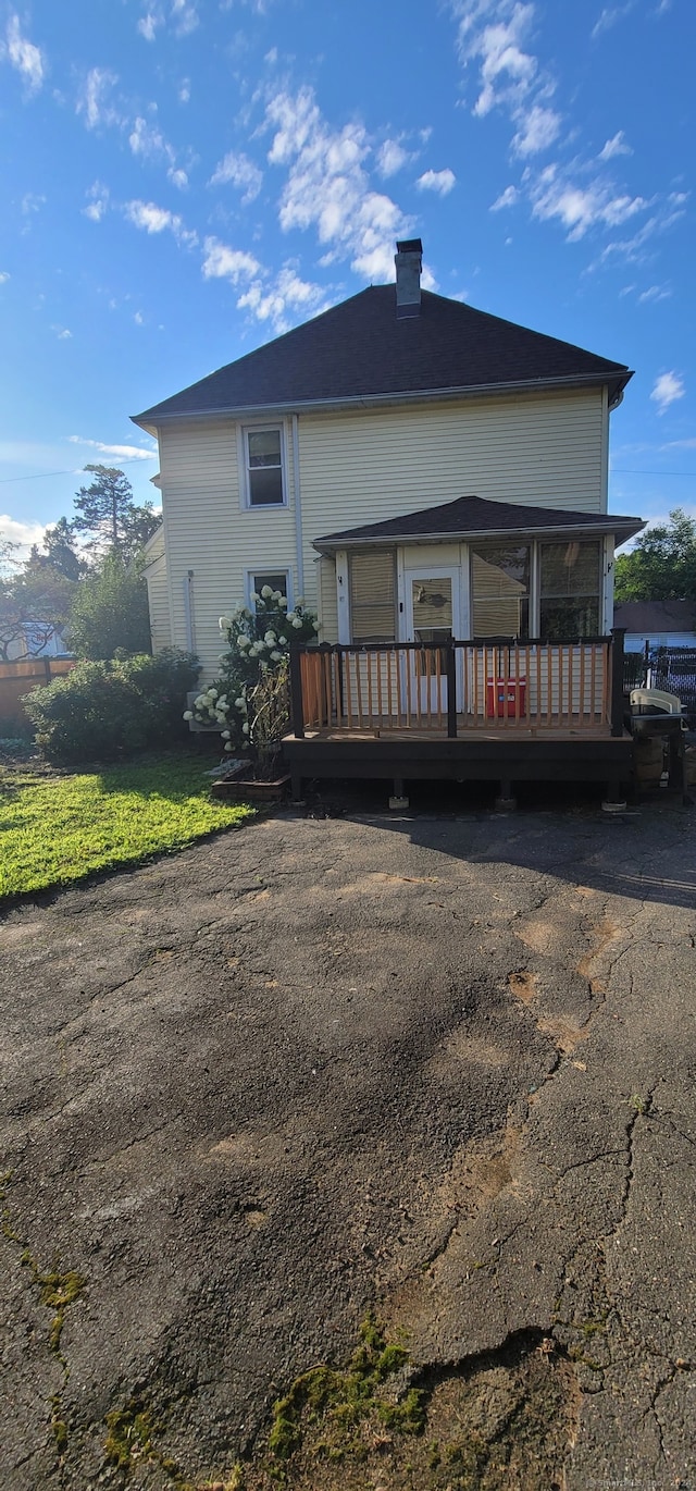 back of house with a deck