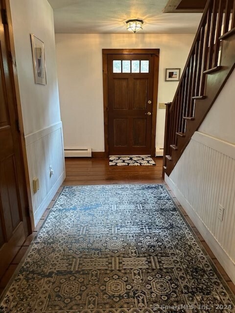 foyer entrance featuring wood-type flooring and baseboard heating