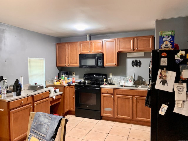 kitchen featuring light tile patterned flooring and black appliances