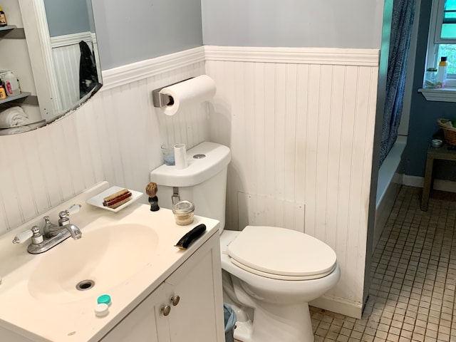 bathroom with tile patterned floors, toilet, and vanity