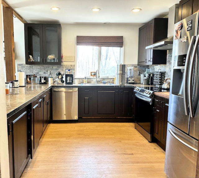 130 Valley Rd, North Branford, CT 06471 - kitchen featuring light wood-style flooring, tasteful backsplash, appliances with stainless steel finishes, and a sink