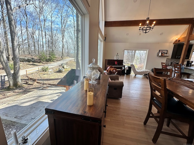 130 Valley Rd, North Branford, CT 06471 - dining space with a chandelier, vaulted ceiling, and wood finished floors