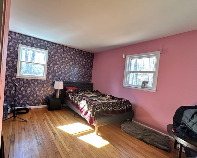 130 Valley Rd, North Branford, CT 06471 - bedroom featuring wood-type flooring, baseboards, multiple windows, and wallpapered walls