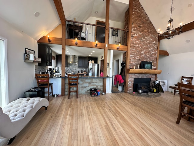 130 Valley Rd, North Branford, CT 06471 - living room featuring light wood-style flooring, a chandelier, and high vaulted ceiling