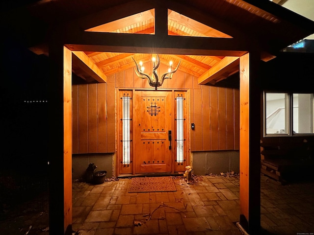 130 Valley Rd, North Branford, CT 06471 - entryway with a chandelier, brick floor, wooden ceiling, and lofted ceiling with beams