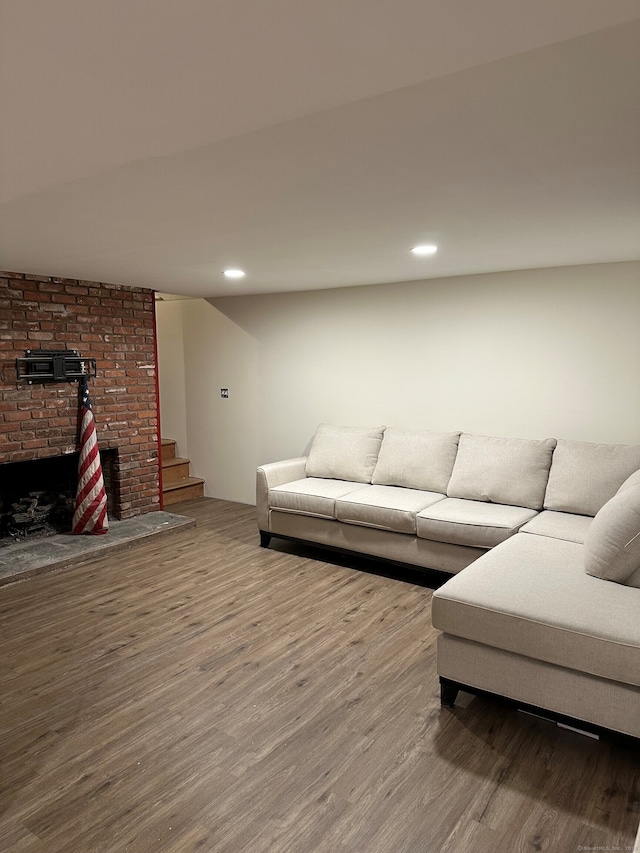 130 Valley Rd, North Branford, CT 06471 - living room with wood finished floors, recessed lighting, a brick fireplace, and stairs