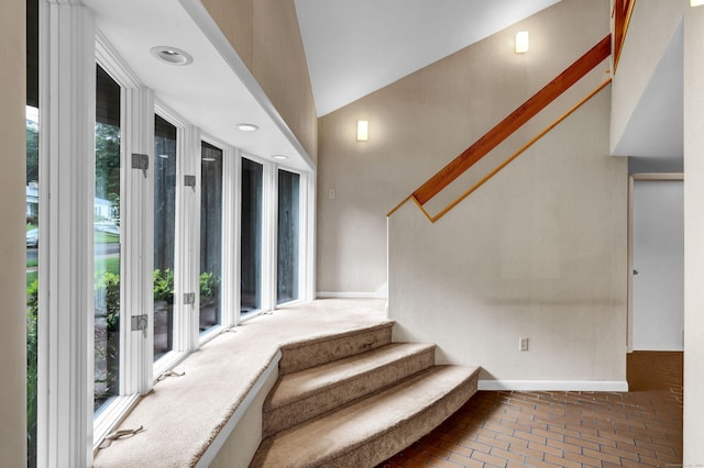 stairway featuring lofted ceiling