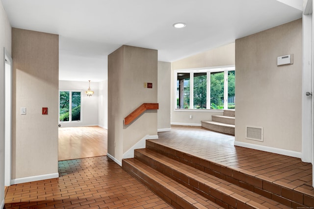 stairway with hardwood / wood-style floors and a wealth of natural light