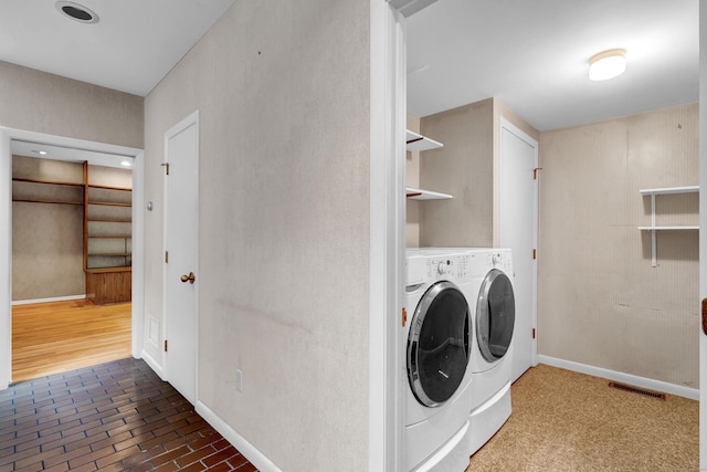 clothes washing area featuring separate washer and dryer