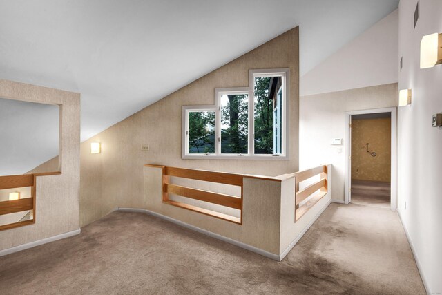 bonus room featuring light carpet and vaulted ceiling