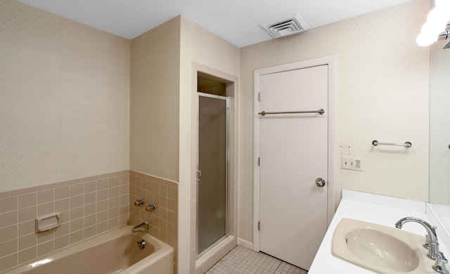 bathroom featuring vanity, shower with separate bathtub, and tile patterned flooring