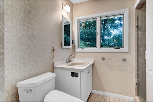 bathroom with vanity, toilet, tile patterned floors, and walk in shower