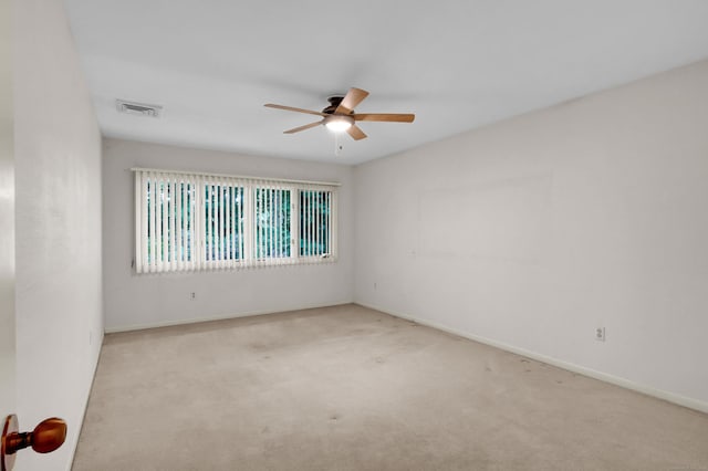 carpeted spare room featuring ceiling fan