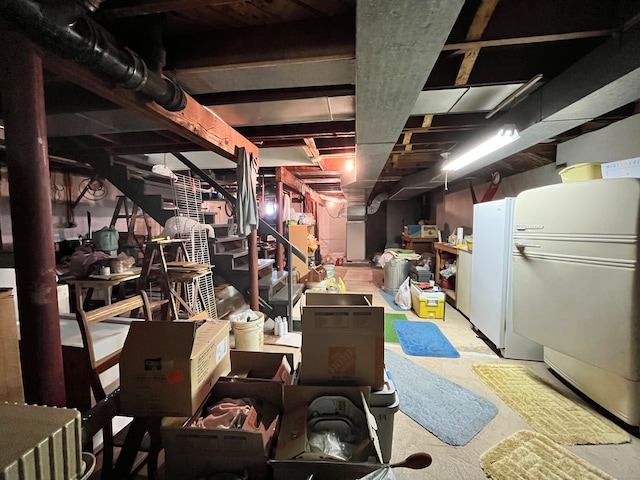 basement with white refrigerator