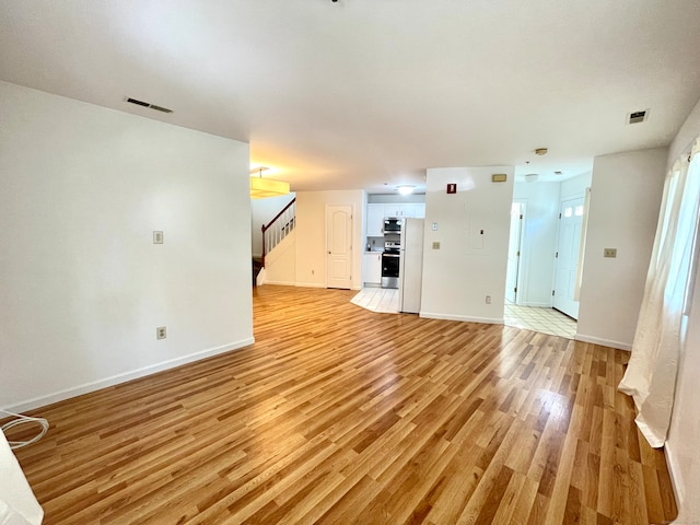 unfurnished living room featuring light tile patterned floors