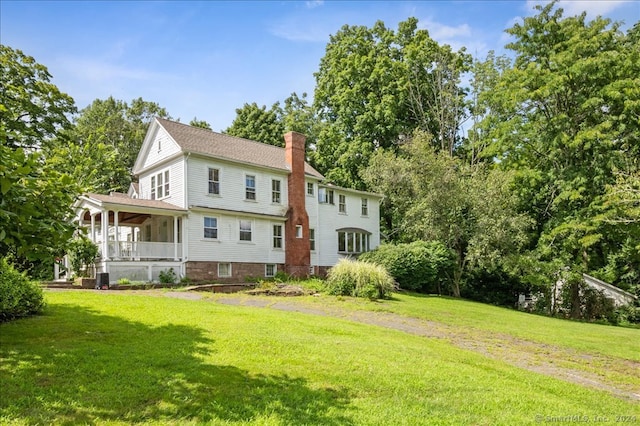 exterior space featuring a porch and a lawn