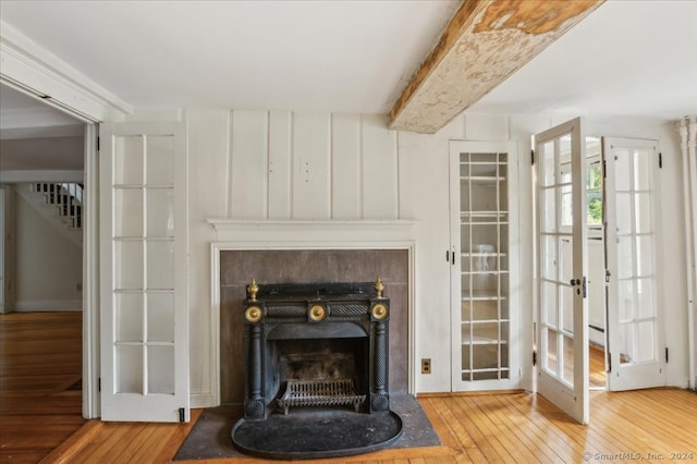 unfurnished living room featuring french doors and wood-type flooring