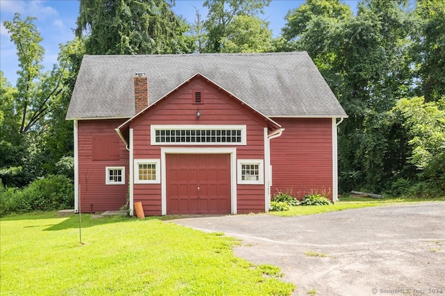 garage with wood walls and a yard