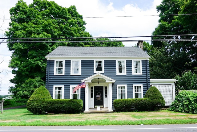 colonial-style house with a front yard