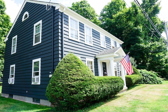 view of side of home featuring a lawn