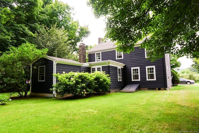 rear view of house featuring a yard