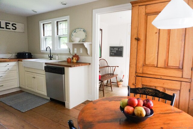 kitchen featuring sink, wooden counters, and dishwasher