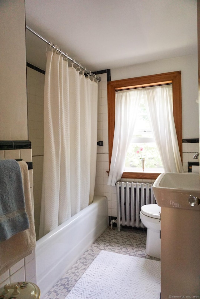 bathroom featuring shower / bathtub combination with curtain, radiator, and toilet