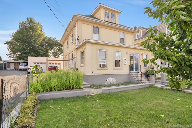 view of front of home with a garage and a front lawn